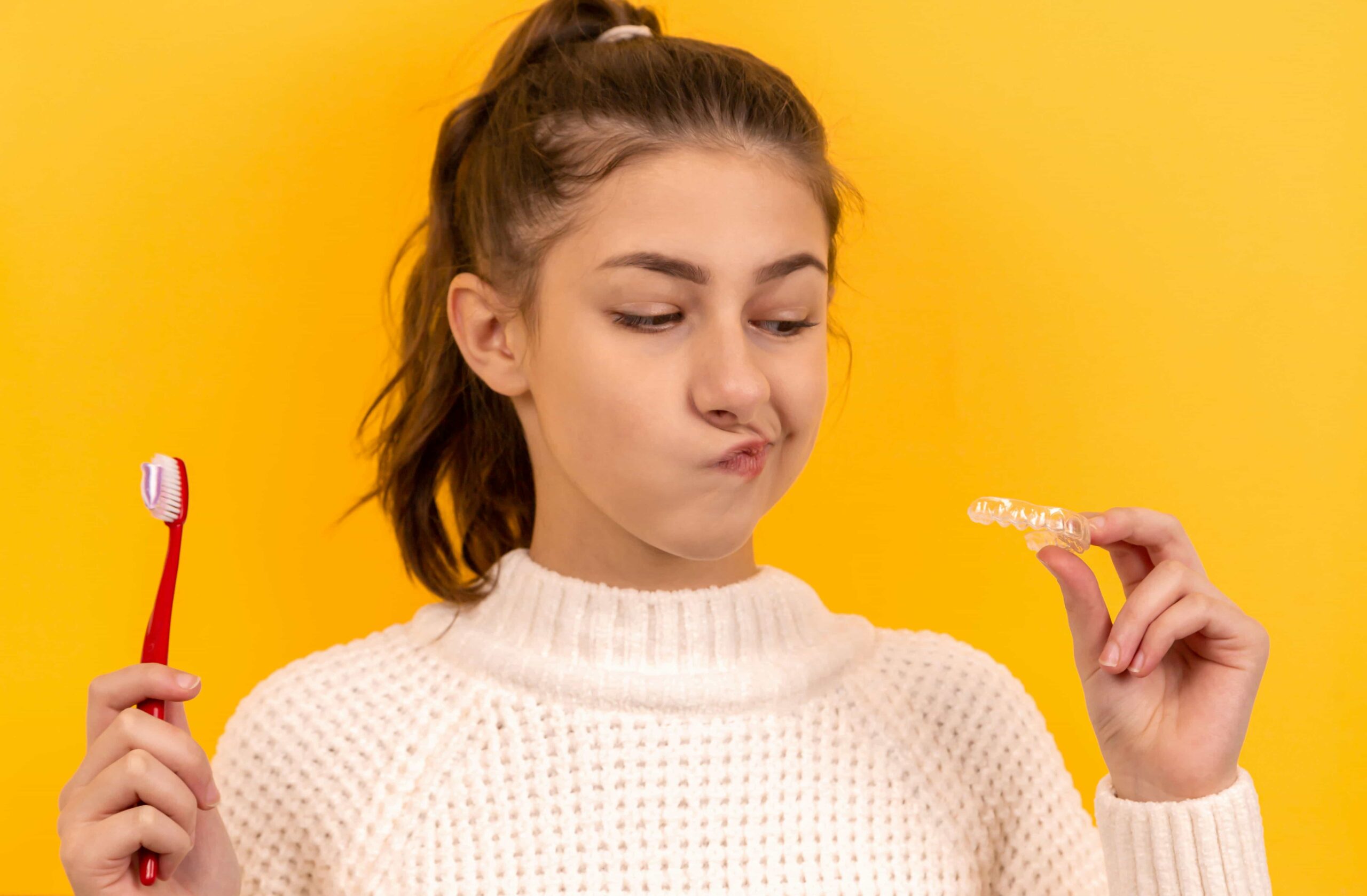 woman holding her retainers